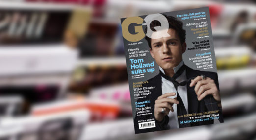GQ cover in front of magazines