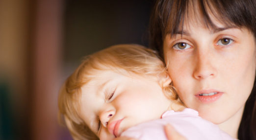 Women holding sleeping child