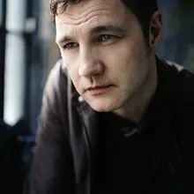 Image of David Morrissey looking to the left of the camera