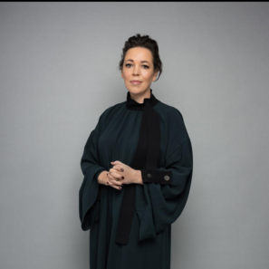 Image of Olivia Colman standing up and looking directly into camera