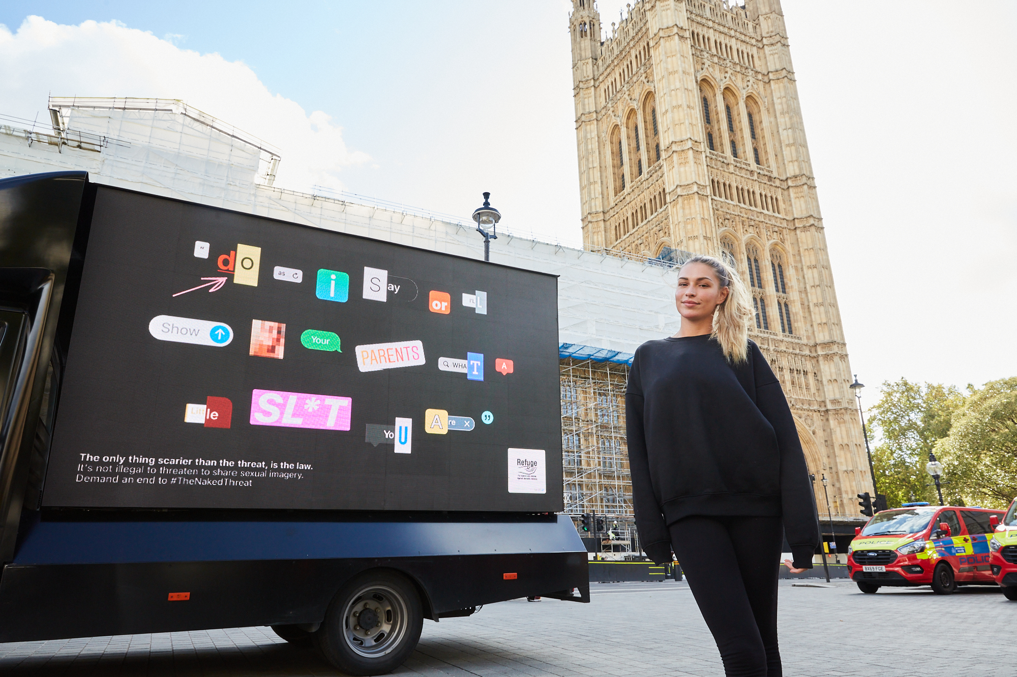 Image of Zara McDermott outside Parliament next to a billboard of the campaign