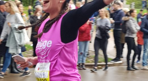 Image of a woman running with a Refuge branded vest