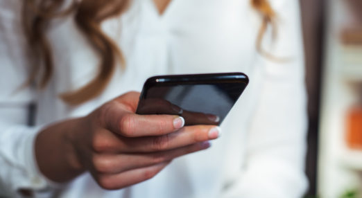Close up image of a woman holding a smartphone