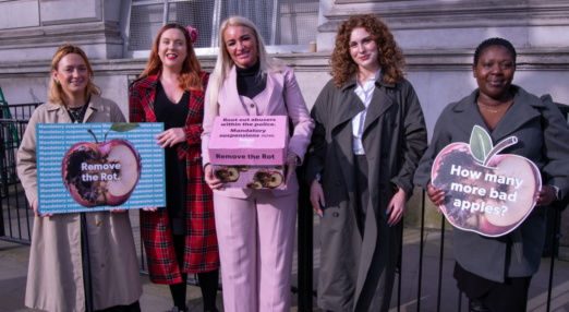 A group of 5 women holding placards and a box containing a petition to government