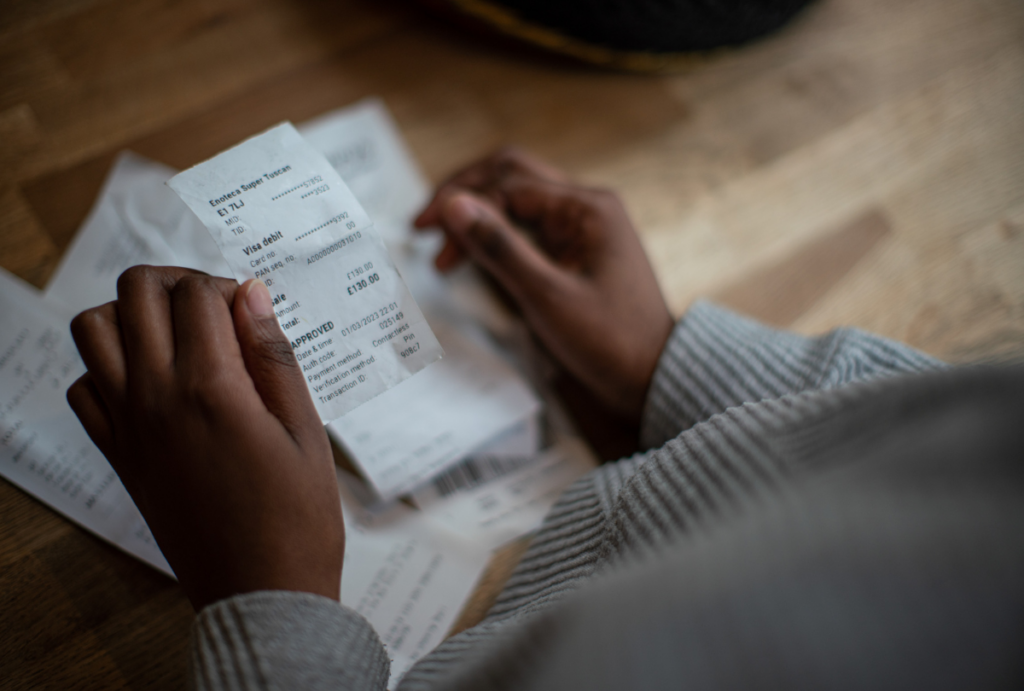 Close up of woman's hands holding a receipt