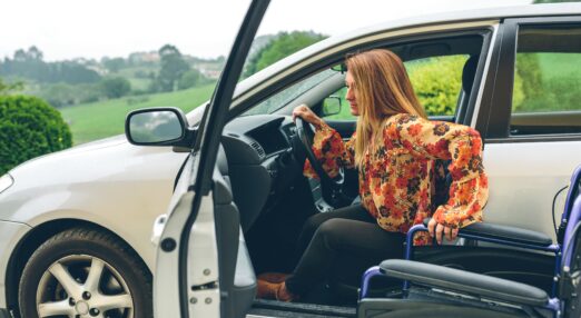 Young woman in a wheelchair leaving the car
