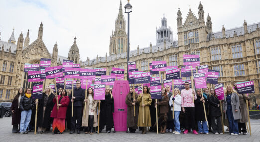 A large group of supporters outside the houses of parliment holding protest signs